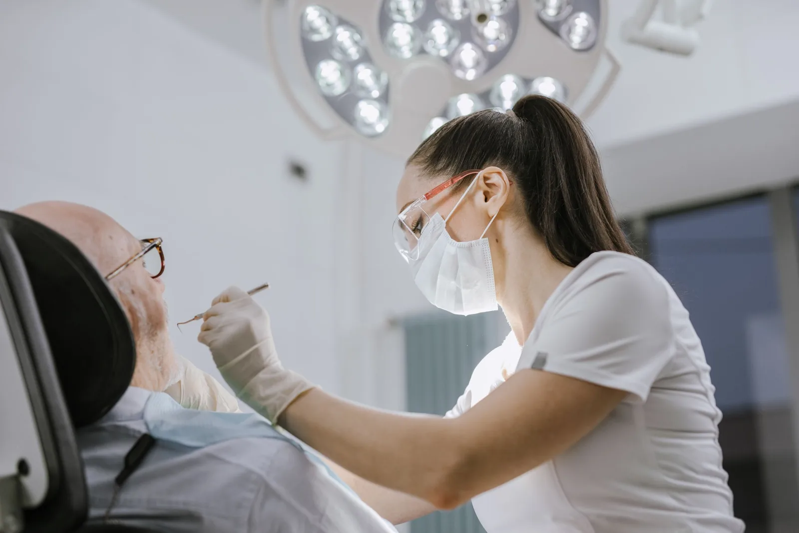 A periodontist examining a patient