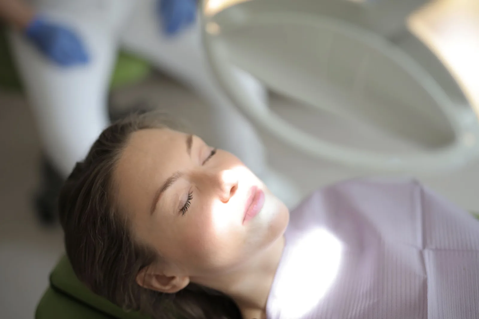 A patient resting calmly in the chair, eyes closed