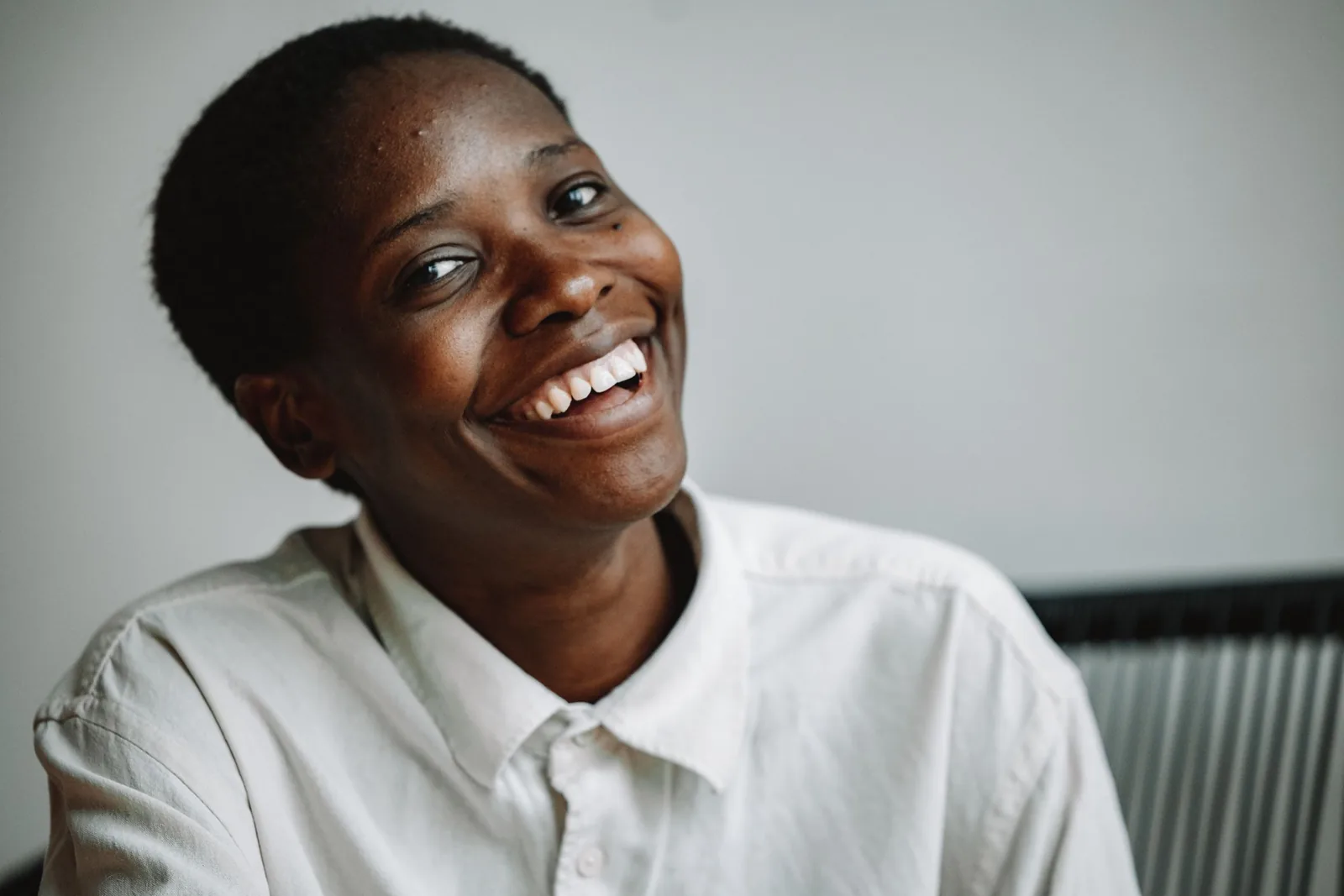 A patient smiling after her appointment at Sapphire Dental Studio
