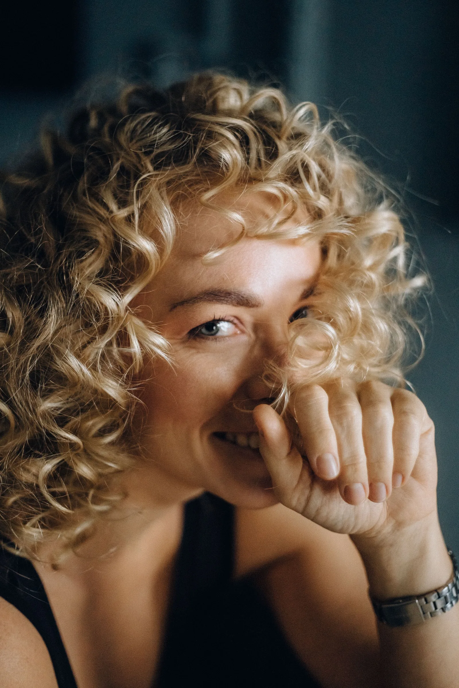 A woman covering her smile with her hand